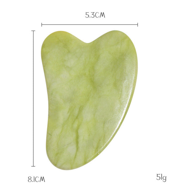Gua sha massage board displayed on skincare background

