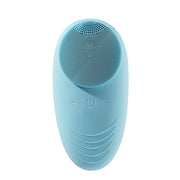 Electric facial brush displayed on clean skincare background

