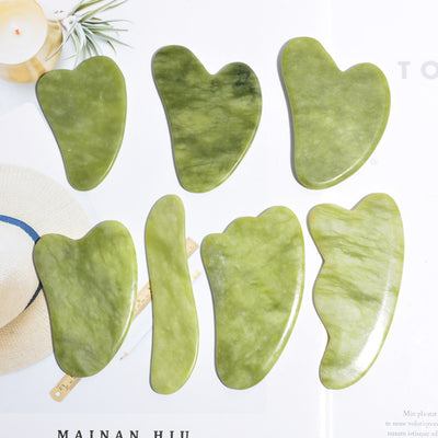 Green jade gua sha massage board for facial skincare

