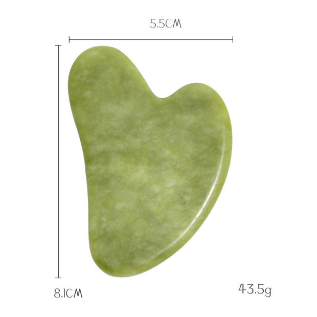 Traditional jade gua sha stone for skincare routine

