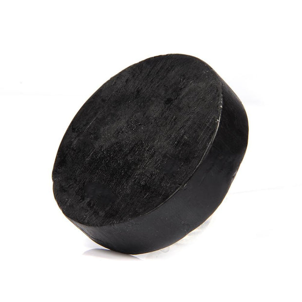 Bamboo charcoal soap bar on wooden spa background

